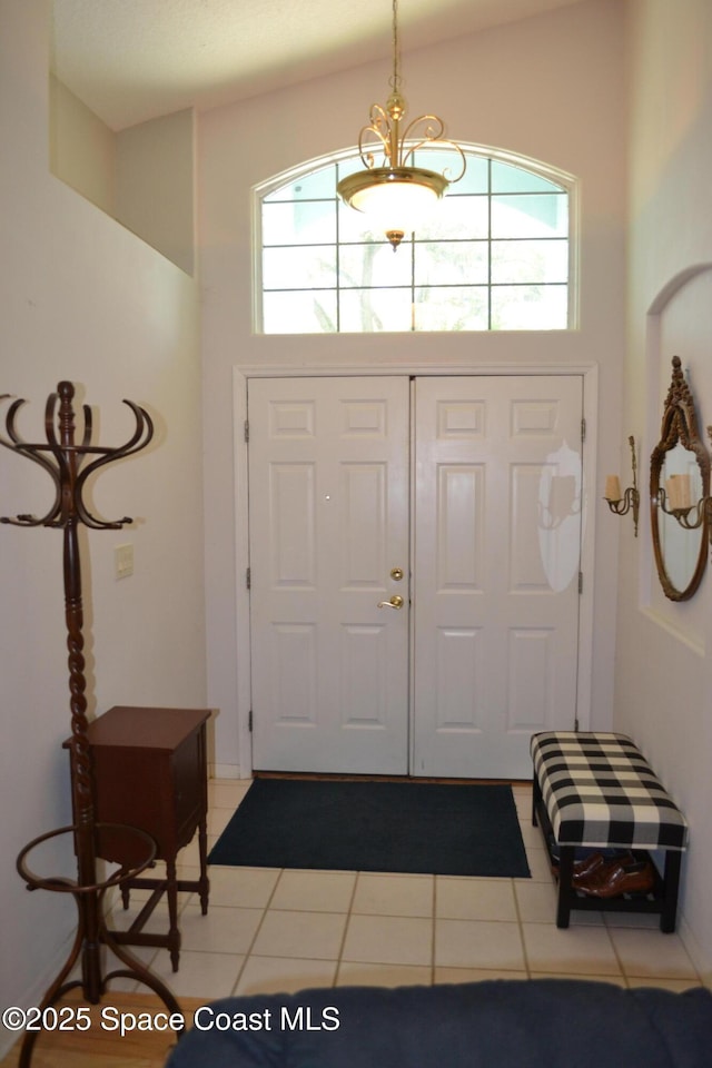 entrance foyer featuring a high ceiling and light tile patterned flooring