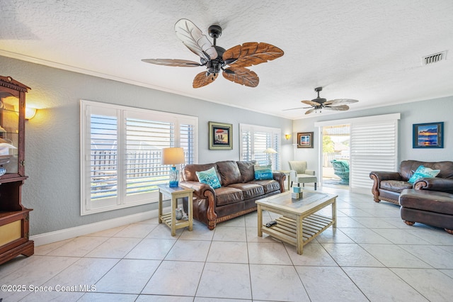 living room with ornamental molding, light tile patterned flooring, and visible vents