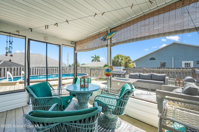 wooden deck featuring outdoor lounge area, a fenced backyard, a fenced in pool, and a grill