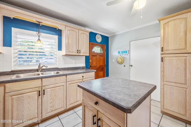 kitchen featuring dark countertops, a sink, and light brown cabinetry