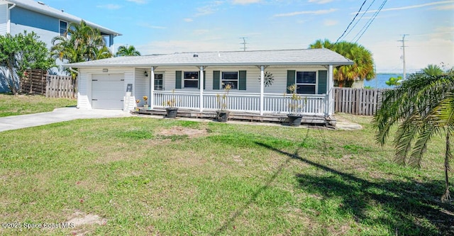 ranch-style home with a front lawn, fence, a porch, and concrete driveway