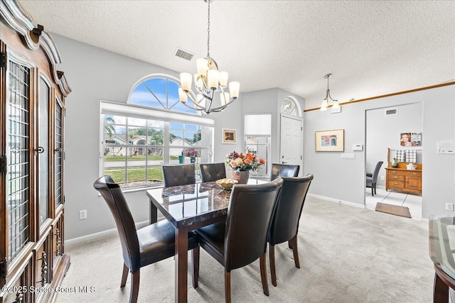 dining area with visible vents, light carpet, a notable chandelier, and a textured ceiling