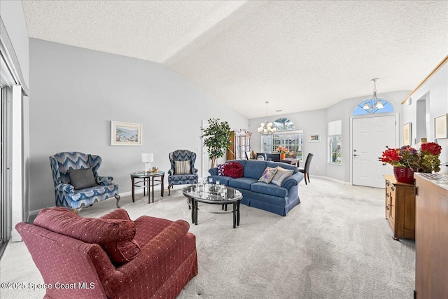 living area featuring lofted ceiling, a textured ceiling, a chandelier, and carpet flooring