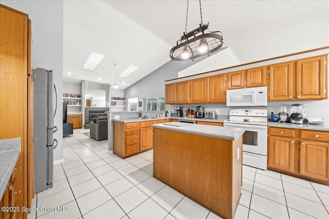 kitchen with white appliances, light tile patterned floors, a peninsula, and open floor plan