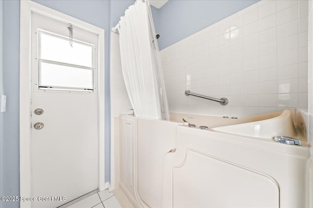 full bath featuring tile patterned floors, curtained shower, and a tub