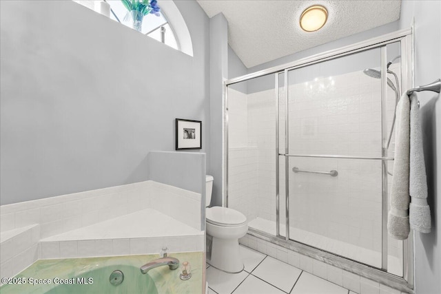 full bathroom featuring tile patterned flooring, a shower stall, toilet, and a textured ceiling