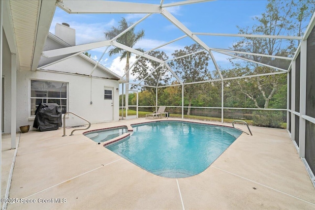 view of pool with a patio, a lanai, and a pool with connected hot tub