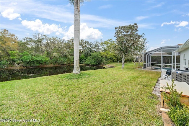 view of yard featuring an outdoor pool and glass enclosure