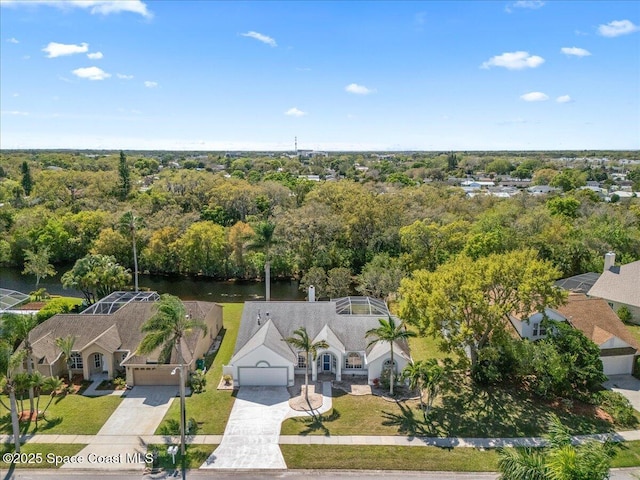 drone / aerial view with a view of trees and a water view