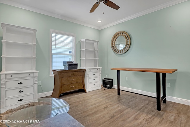 office space featuring light wood-style flooring, ornamental molding, ceiling fan, and baseboards