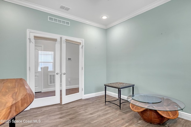 sitting room featuring ornamental molding, french doors, wood finished floors, and visible vents