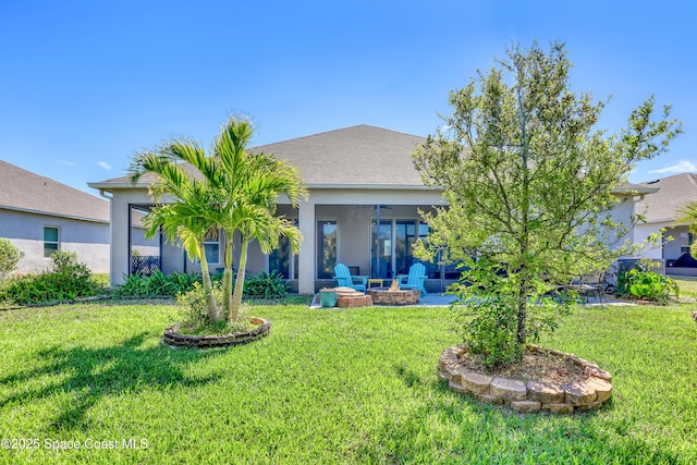 view of front of property with an outdoor fire pit, stucco siding, and a front yard