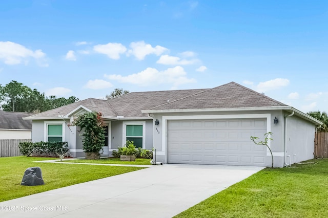 ranch-style house featuring stucco siding, concrete driveway, an attached garage, a front yard, and fence