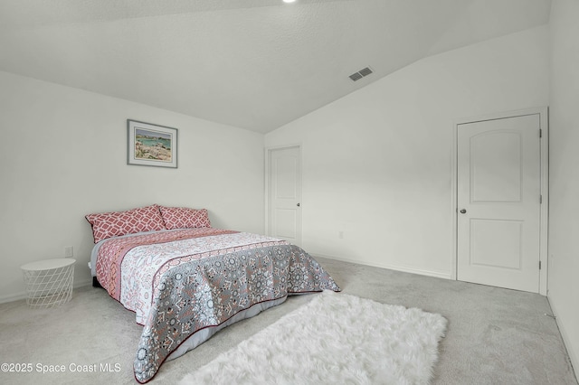 bedroom featuring lofted ceiling, baseboards, visible vents, and carpet flooring