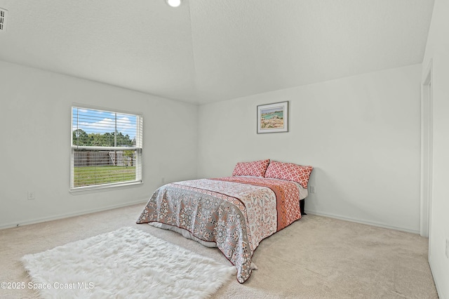 bedroom featuring a textured ceiling, carpet floors, visible vents, and baseboards