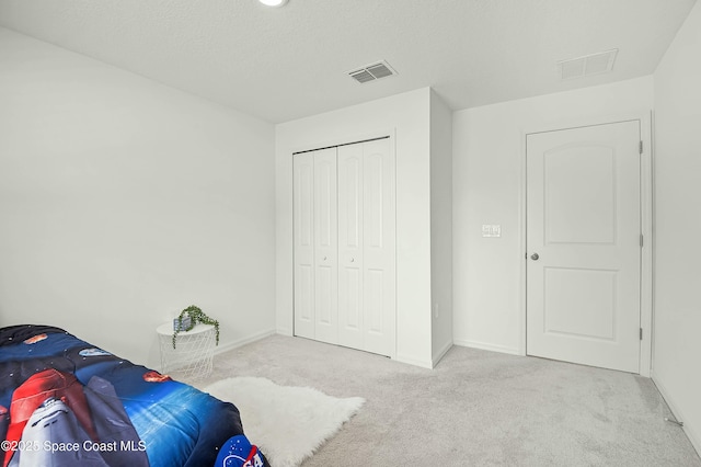 bedroom with carpet, visible vents, and baseboards