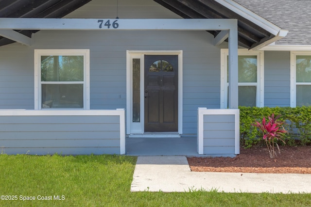 entrance to property with roof with shingles