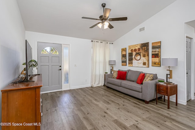 foyer featuring visible vents, ceiling fan, vaulted ceiling, wood finished floors, and baseboards