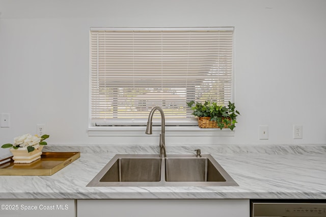 interior details featuring a sink and dishwasher