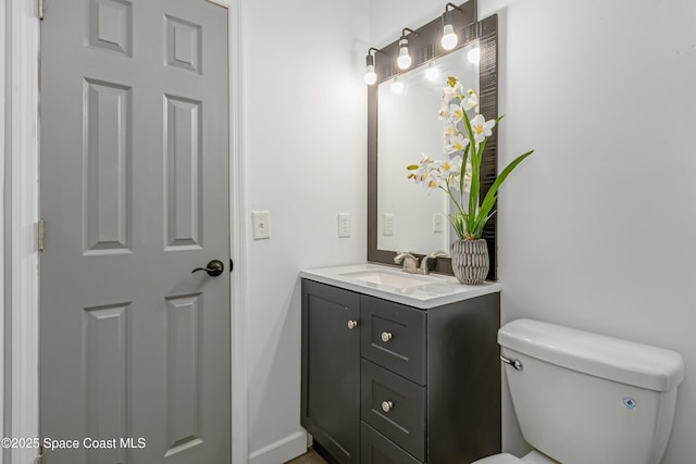 bathroom featuring toilet and vanity