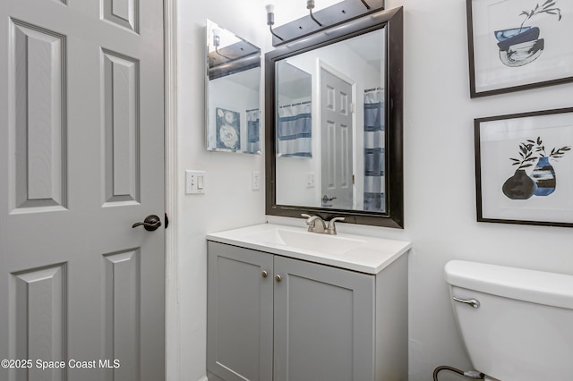 bathroom featuring vanity and toilet