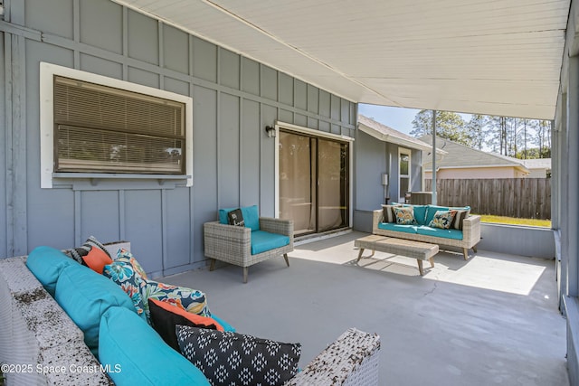 view of patio featuring fence and an outdoor living space