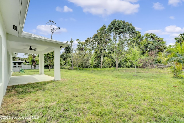 view of yard with a patio area and ceiling fan