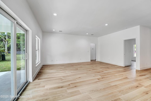 spare room with light wood-type flooring, plenty of natural light, and recessed lighting