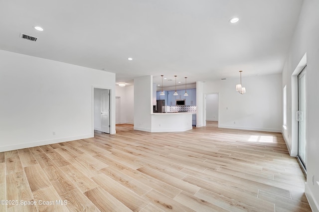 unfurnished living room featuring light wood-style flooring, visible vents, baseboards, and recessed lighting