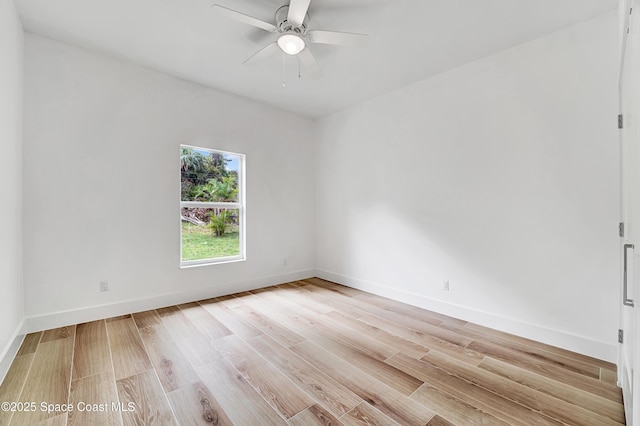 empty room featuring baseboards, ceiling fan, and light wood finished floors