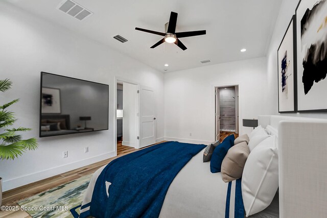 bedroom featuring baseboards, visible vents, wood finished floors, and recessed lighting