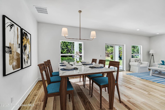 dining area featuring recessed lighting, baseboards, visible vents, and light wood finished floors