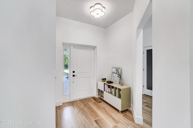 entrance foyer featuring light wood finished floors and baseboards