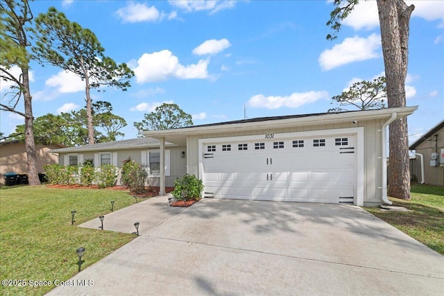 single story home featuring an attached garage, concrete driveway, and a front yard