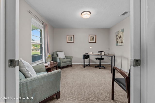 office space with carpet floors, visible vents, baseboards, and a textured ceiling