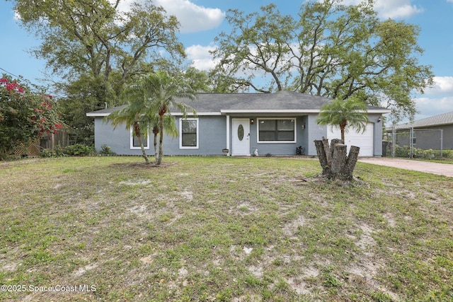 single story home with concrete driveway, an attached garage, fence, and a front yard