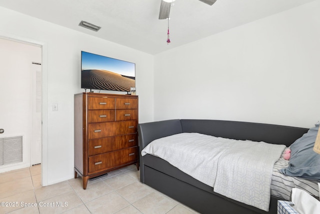 bedroom with visible vents, a ceiling fan, and light tile patterned flooring