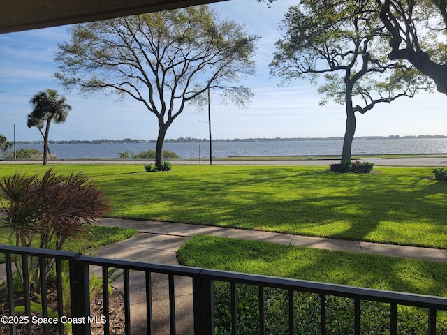 exterior space with a water view and a lawn