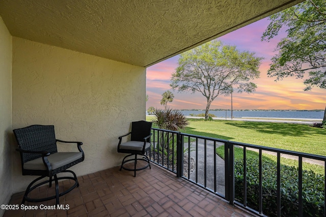 balcony featuring a water view