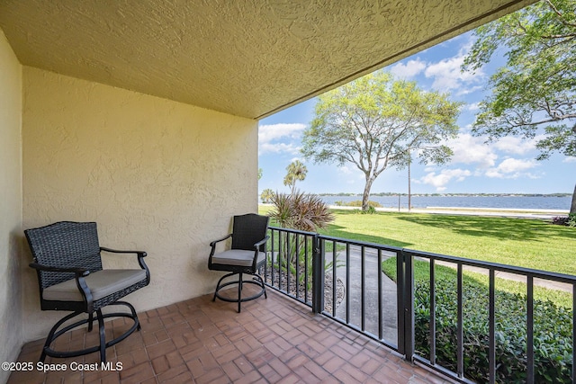 balcony featuring a water view