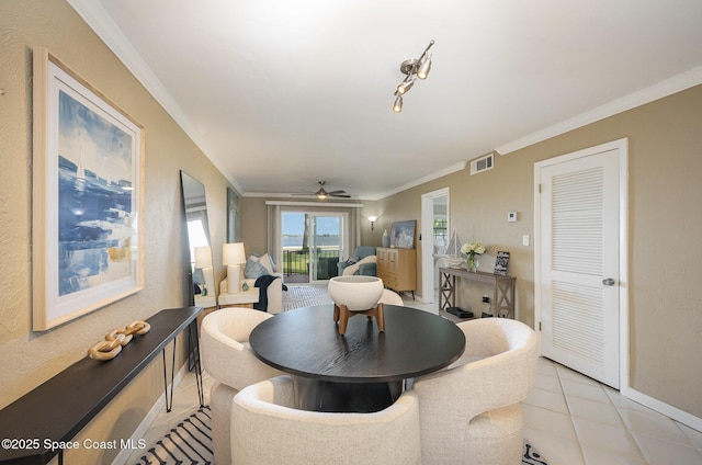 dining area featuring baseboards, visible vents, light tile patterned flooring, ceiling fan, and crown molding