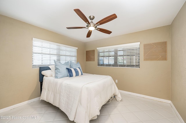 bedroom with light tile patterned floors, baseboards, and ceiling fan