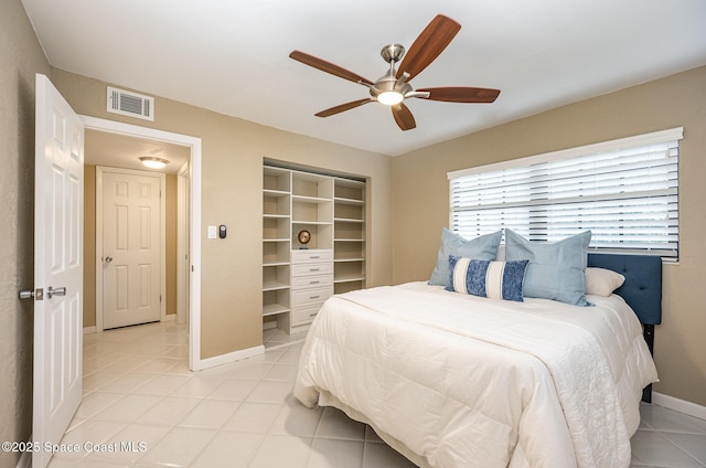 bedroom featuring visible vents, baseboards, light tile patterned flooring, and a ceiling fan