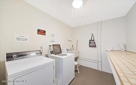 community laundry room with a sink and washing machine and dryer