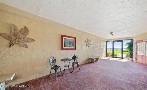 interior space with carpet flooring and a textured ceiling