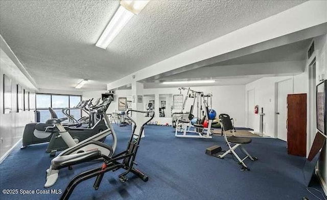 gym with visible vents and a textured ceiling