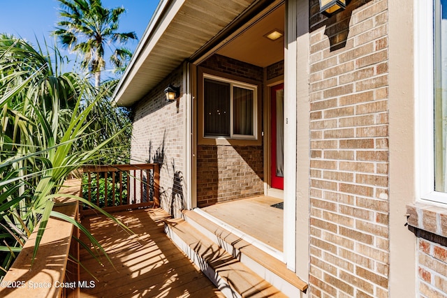 property entrance with brick siding