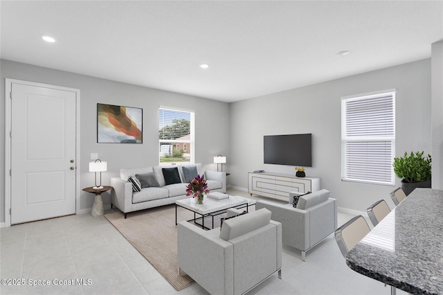 living area with light tile patterned floors, baseboards, and recessed lighting