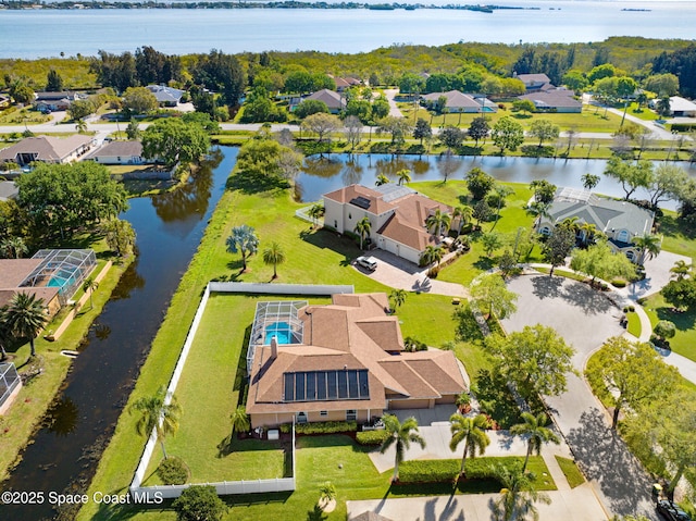 drone / aerial view with a residential view and a water view