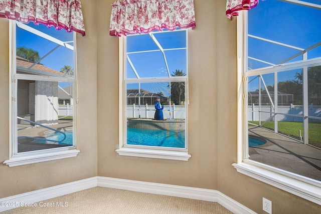 interior space featuring baseboards, plenty of natural light, and a sunroom